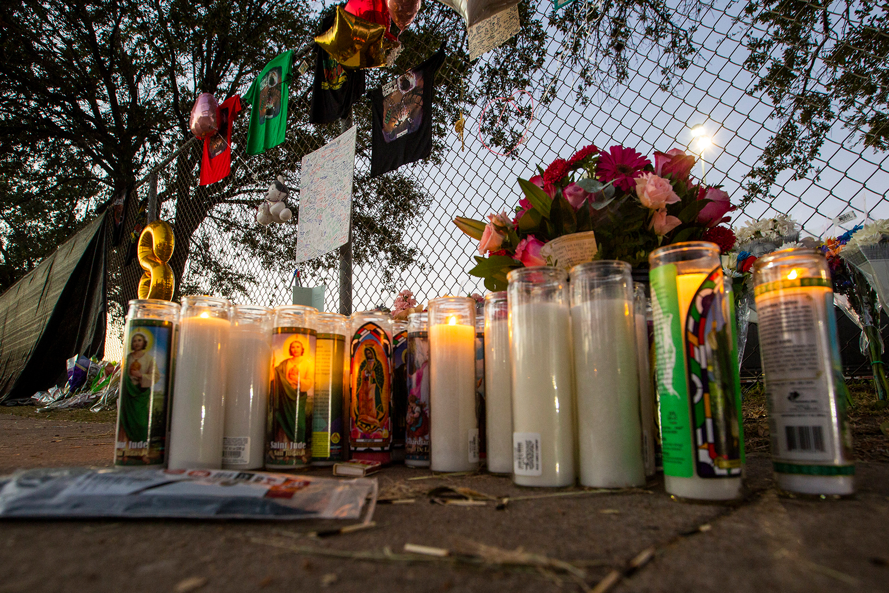Candles are lit at a makeshift memorial on November 7, 2021 at the NRG Park grounds where eight people died in a crowd surge at the Astroworld Festival in Houston, Texas. - Authorities in Texas opened a criminal investigation Saturday into a tragedy in which the crowd at a huge Travis Scott rap concert surged toward the stage in a crush that killed eight people and sent dozens to the hospital.Around 50,000 people were in the audience at Houston's NRG Park Friday night when the crowd started pushing toward the stage as Scott was performing, triggering chaotic scenes. (Photo by Thomas Shea / AFP) (Photo by THOMAS SHEA/AFP via Getty Images)